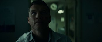 Movie still from “Fractured” (2019), directed by Brad Anderson – A person wearing a white shirt; Close Up shot, Low angle