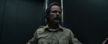 Movie still from “Fractured” (2019), directed by Brad Anderson – A person wearing a uniform; Close Up shot, Low angle