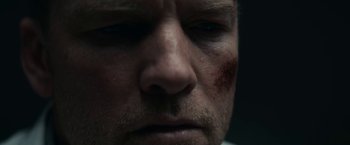 Movie still from “Fractured” (2019), directed by Brad Anderson – A man's face with blood all over his face; Extreme Close Up shot, Low angle