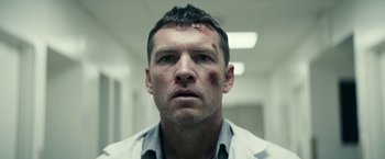 Movie still from “Fractured” (2019), directed by Brad Anderson – A person with a bruise on his face; Close Up shot, Low angle