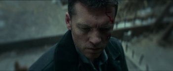 Movie still from “Fractured” (2019), directed by Brad Anderson – A person wearing a jacket with blood on his face; Close Up shot, Low angle