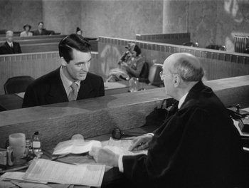 Movie still from “My Favorite Wife” (1940), directed by Garson Kanin – Two men are sitting in a court room; Medium shot, Over the shoulder angle