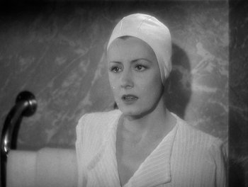 Movie still from “My Favorite Wife” (1940), directed by Garson Kanin – A black and white photo of a woman wearing a white hat; Close Up shot, Low angle