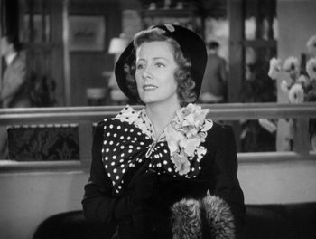 Movie still from “My Favorite Wife” (1940), directed by Garson Kanin – An old photo of a woman wearing a hat; Medium shot, Low angle