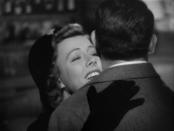 Movie still from “My Favorite Wife” (1940), directed by Garson Kanin – An old black and white photo of a man and a woman hugging; Close Up shot, Over the shoulder angle