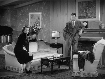 Movie still from “My Favorite Wife” (1940), directed by Garson Kanin – A man and a woman are posing for a picture; Wide shot, High angle