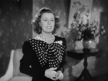 Movie still from “My Favorite Wife” (1940), directed by Garson Kanin – An old photo of a woman wearing a polka dot bow tie; Medium shot, High angle
