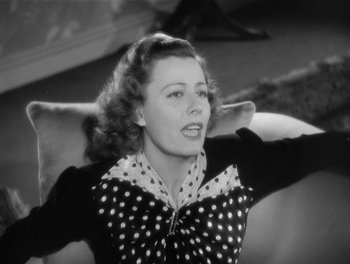 Movie still from “My Favorite Wife” (1940), directed by Garson Kanin – An old black and white photo of a woman in a polka dot dress; Close Up shot, High angle