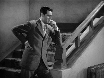 Movie still from “My Favorite Wife” (1940), directed by Garson Kanin – A black and white photo of a man in a suit and tie; Medium shot, High angle
