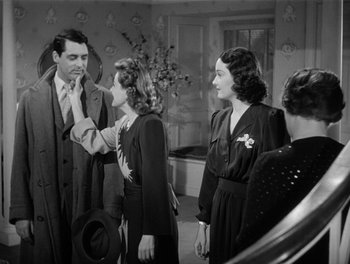 Movie still from “My Favorite Wife” (1940), directed by Garson Kanin – A group of people standing around each other; Medium shot, Over the shoulder angle
