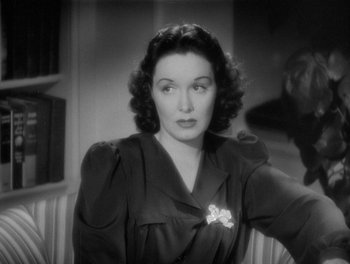 Movie still from “My Favorite Wife” (1940), directed by Garson Kanin – An old black and white photo of a woman; Close Up shot, Over the shoulder angle