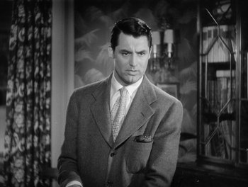 Movie still from “My Favorite Wife” (1940), directed by Garson Kanin – A black and white photo of a man in a suit and tie; Close Up shot, Over the shoulder angle
