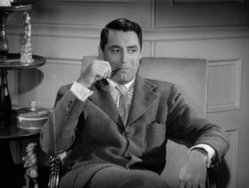 Movie still from “My Favorite Wife” (1940), directed by Garson Kanin – A black and white photo of a man sitting in a chair; Medium shot, High angle