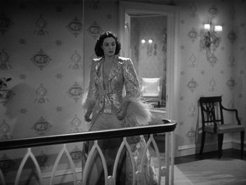 Movie still from “My Favorite Wife” (1940), directed by Garson Kanin – An old photo of a woman standing in a room; Medium shot, High angle