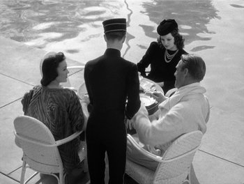 Movie still from “My Favorite Wife” (1940), directed by Garson Kanin – A group of people sitting around a table; Medium shot, High angle