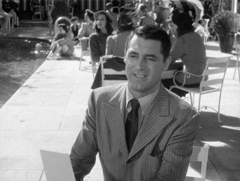 Movie still from “My Favorite Wife” (1940), directed by Garson Kanin – Black and white photograph of a man in a suit; Medium shot, Over the shoulder angle
