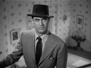 Movie still from “My Favorite Wife” (1940), directed by Garson Kanin – A black and white photo of a man in a suit and hat; Close Up shot, Low angle