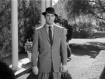 Movie still from “My Favorite Wife” (1940), directed by Garson Kanin – A black and white photo of a man wearing a suit and hat; Medium shot, Low angle