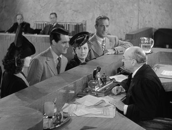 Movie still from “My Favorite Wife” (1940), directed by Garson Kanin – A group of people sitting around a table; Medium shot, Over the shoulder angle