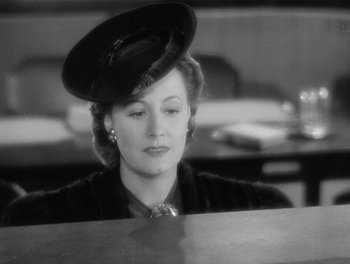 Movie still from “My Favorite Wife” (1940), directed by Garson Kanin – A woman with a hat sitting at a table; Close Up shot, Low angle