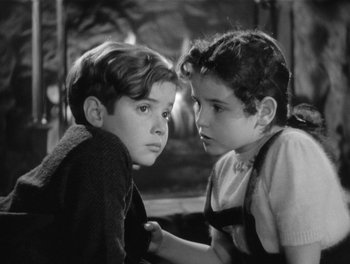 Movie still from “My Favorite Wife” (1940), directed by Garson Kanin – Two young boys looking at each other in a black and white photo; Close Up shot, High angle