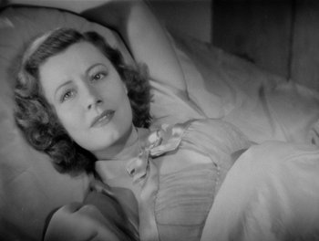 Movie still from “My Favorite Wife” (1940), directed by Garson Kanin – An old photo of a woman laying in a bed; Close Up shot, High angle