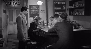 Movie still from “My Gun Is Quick” (1957), directed by Victor Saville – A black and white photo of people sitting at a bar; Medium shot, High angle