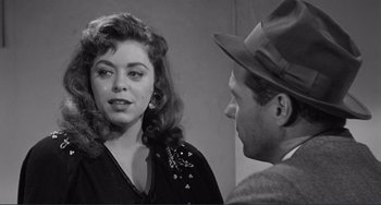 Movie still from “My Gun Is Quick” (1957), directed by Victor Saville – An old black and white photo of a man and a woman talking; Close Up shot, Over the shoulder angle