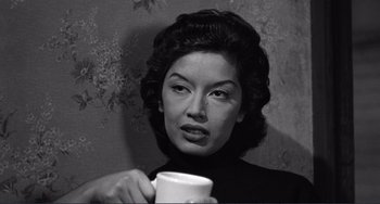 Movie still from “My Gun Is Quick” (1957), directed by Victor Saville – A woman is holding a coffee cup in her hands; Close Up shot, High angle