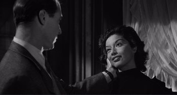 Movie still from “My Gun Is Quick” (1957), directed by Victor Saville – A man and a woman are talking to each other; Close Up shot, Over the shoulder angle