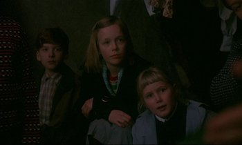 Movie still from “My Life as a Dog” (1985), directed by Lasse Hallström – A group of children sitting in a dark room; Medium shot, Low angle