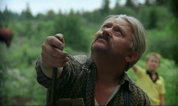 Movie still from “My Life as a Dog” (1985), directed by Lasse Hallström – An older man holding a stick in his hand; Close Up shot, Low angle