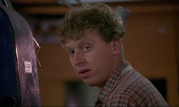 Movie still from “My Life as a Dog” (1985), directed by Lasse Hallström – A person wearing a checkered shirt; Close Up shot, Low angle