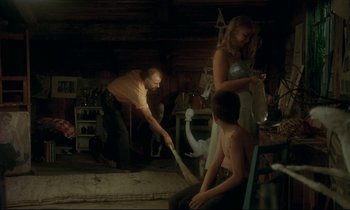 Movie still from “My Life as a Dog” (1985), directed by Lasse Hallström – A group of people sitting in a room; Wide shot, High angle