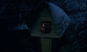 Movie still from “My Life as a Dog” (1985), directed by Lasse Hallström – A person looking out of a window at night in the dark; Extreme Wide shot, Overhead angle
