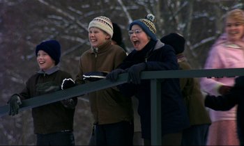 Movie still from “My Life as a Dog” (1985), directed by Lasse Hallström – A group of people standing next to each other on top of a railing; Wide shot, Low angle