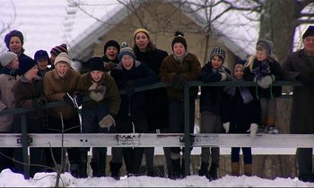 Movie still from “My Life as a Dog” (1985), directed by Lasse Hallström – A group of people standing next to each other in the snow; Wide shot, Low angle