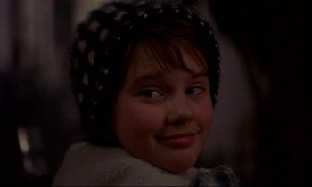 Movie still from “My Life as a Dog” (1985), directed by Lasse Hallström – A person wearing a hat; Close Up shot, Over the shoulder angle