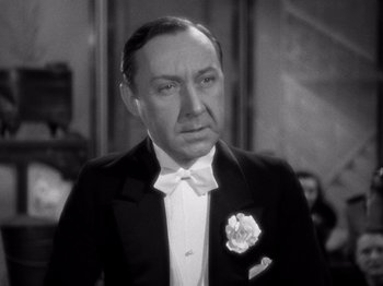 Movie still from “My Man Godfrey” (1936), directed by Gregory La Cava – An old photo of a man in a tuxedo; Close Up shot, Low angle