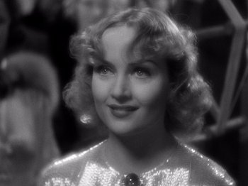 Movie still from “My Man Godfrey” (1936), directed by Gregory La Cava – A black - and - white photo of a woman in a sequined dress; Close Up shot, Over the shoulder angle