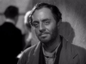 Movie still from “My Man Godfrey” (1936), directed by Gregory La Cava – An old black and white photo of a man with a beard; Close Up shot, Over the shoulder angle