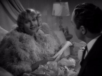Movie still from “My Man Godfrey” (1936), directed by Gregory La Cava – An old photo of a man and a woman talking to each other; Medium shot, High angle