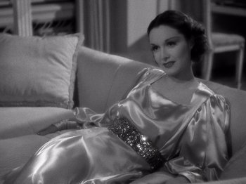 Movie still from “My Man Godfrey” (1936), directed by Gregory La Cava – A black and white photo of a woman sitting on a couch; Medium shot, High angle