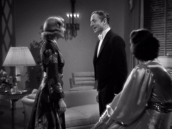 Movie still from “My Man Godfrey” (1936), directed by Gregory La Cava – Two women and a man are talking to each other; Medium shot, Over the shoulder angle