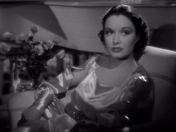 Movie still from “My Man Godfrey” (1936), directed by Gregory La Cava – A woman sitting in a chair wearing a satin dress; Close Up shot, High angle