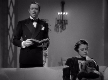 Movie still from “My Man Godfrey” (1936), directed by Gregory La Cava – A man and a woman in formal wear holding a book; Medium shot, Low angle