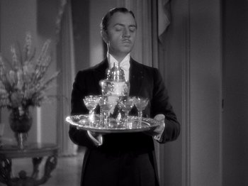 Movie still from “My Man Godfrey” (1936), directed by Gregory La Cava – A man holding a tray of wine glasses in front of him; Medium shot, Low angle