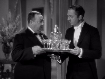 Movie still from “My Man Godfrey” (1936), directed by Gregory La Cava – Two men in tuxedos holding a tray of drinks; Medium shot, Low angle