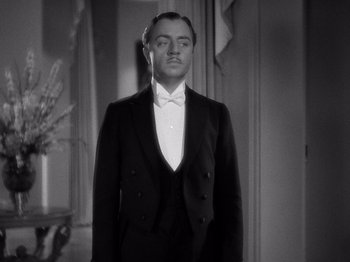 Movie still from “My Man Godfrey” (1936), directed by Gregory La Cava – A man in a suit standing in front of a mirror; Medium shot, Low angle