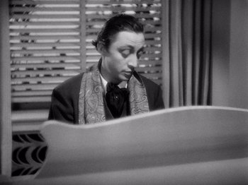 Movie still from “My Man Godfrey” (1936), directed by Gregory La Cava – A black and white photo of a man sitting at a piano; Close Up shot, High angle